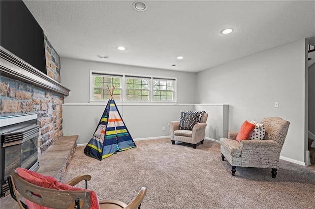 recreation room with carpet floors, recessed lighting, a stone fireplace, and baseboards