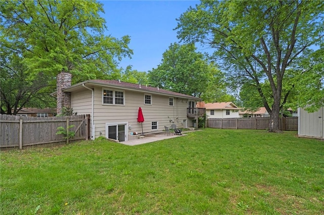 back of property with a patio and a chimney
