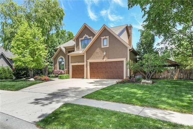 12843 Noland St, Overland Park, KS 66213 - traditional-style house featuring stucco siding, a chimney, driveway, and an attached garage