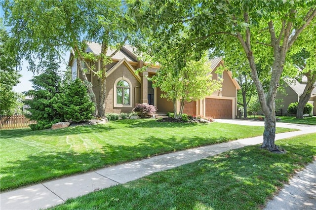 12843 Noland St, Overland Park, KS 66213 - view of front facade featuring stucco siding, driveway, and an attached garage