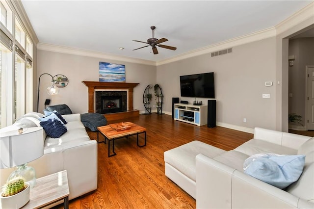 12843 Noland St, Overland Park, KS 66213 - living room featuring a ceiling fan, wood finished floors, crown molding, and a fireplace