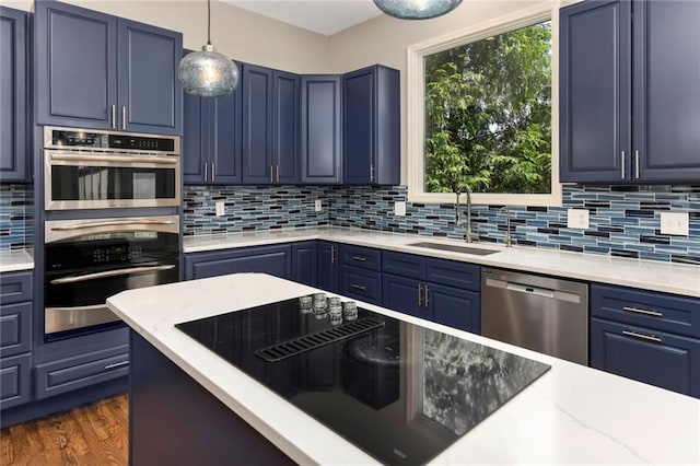 12843 Noland St, Overland Park, KS 66213 - kitchen featuring appliances with stainless steel finishes, blue cabinets, and tasteful backsplash