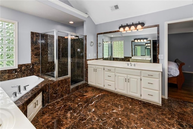 12843 Noland St, Overland Park, KS 66213 - ensuite bathroom with vanity, a garden tub, a stall shower, lofted ceiling, and marble finish flooring