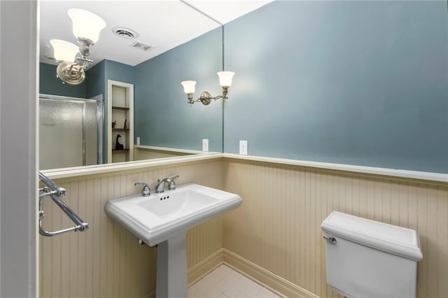 12843 Noland St, Overland Park, KS 66213 - bathroom featuring wainscoting and a stall shower