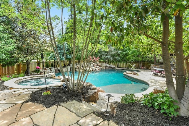 12843 Noland St, Overland Park, KS 66213 - view of pool with a fenced backyard, a patio area, an in-ground hot tub, and view of wooded area
