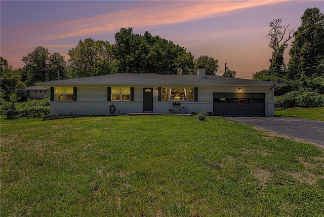 6405 Haskell Ave, Kansas City, KS 66104 - ranch-style home with a garage, driveway, a front yard, and a chimney