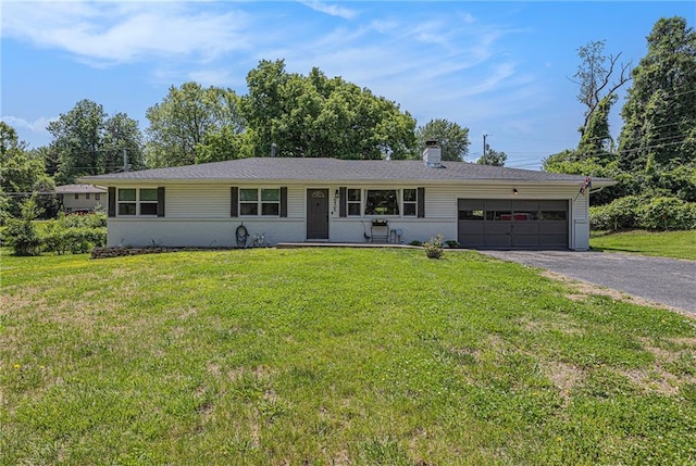 6405 Haskell Ave, Kansas City, KS 66104 - ranch-style home featuring an attached garage, driveway, a front yard, and a chimney