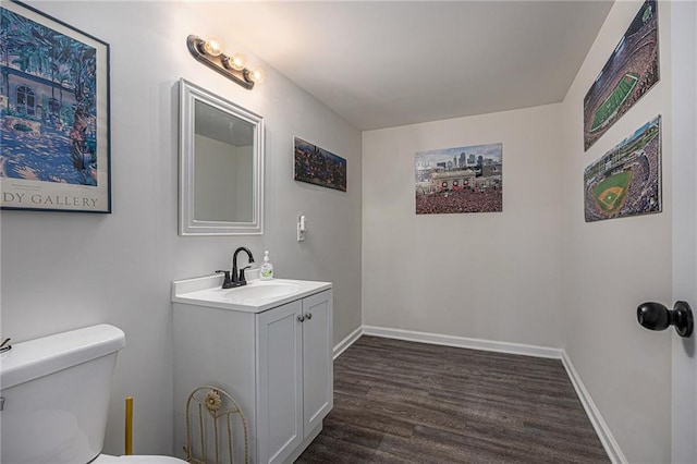 6405 Haskell Ave, Kansas City, KS 66104 - half bathroom with wood finished floors, vanity, toilet, and baseboards