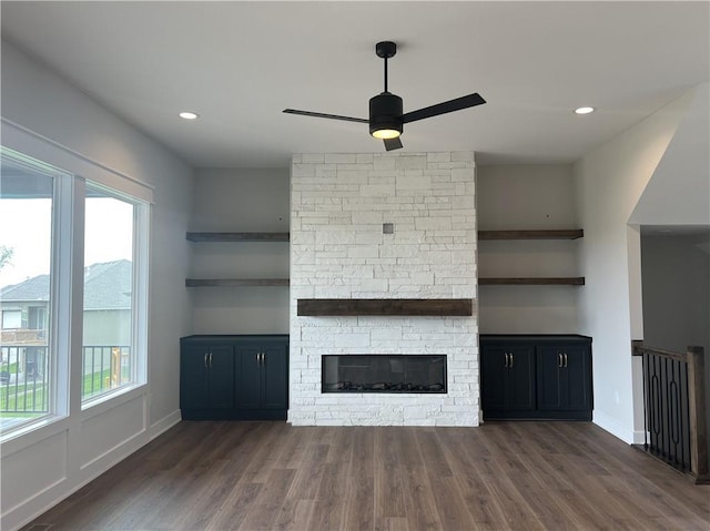 unfurnished living room featuring a ceiling fan, plenty of natural light, dark wood-style floors, and recessed lighting