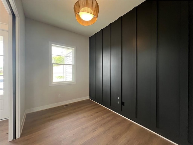 unfurnished room featuring light wood-type flooring and baseboards
