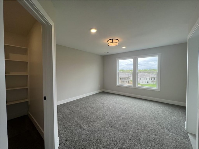 carpeted empty room with baseboards and recessed lighting