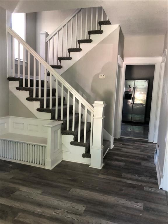 2063 Springfield Blvd, Kansas City, KS 66101 - stairs featuring wood finished floors