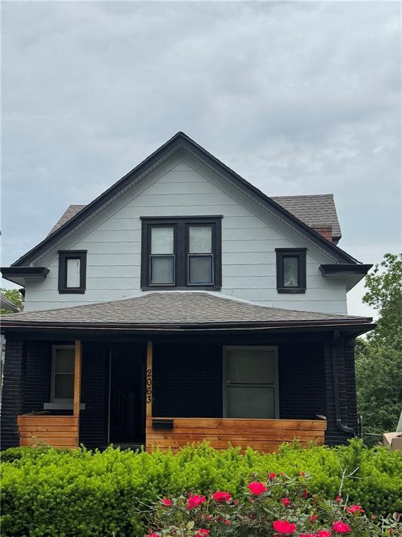 2063 Springfield Blvd, Kansas City, KS 66101 - view of front of property featuring a porch and a shingled roof