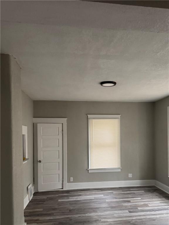 2063 Springfield Blvd, Kansas City, KS 66101 - spare room with wood finished floors and baseboards