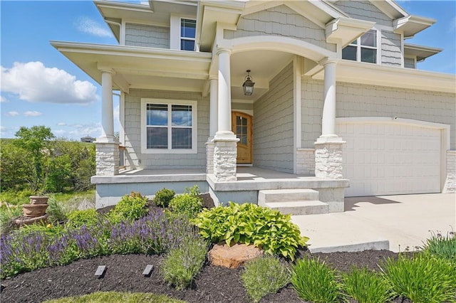 11588 S Houston St, Olathe, KS 66061 - property entrance featuring covered porch, an attached garage, and driveway