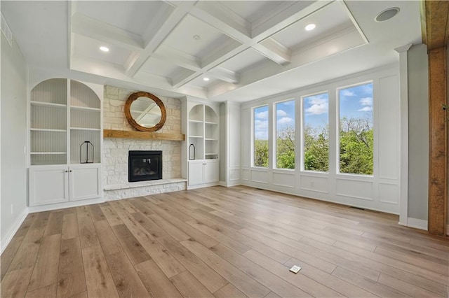 11588 S Houston St, Olathe, KS 66061 - unfurnished living room featuring wood finished floors, built in features, beamed ceiling, coffered ceiling, and a stone fireplace