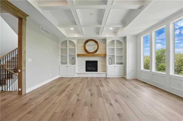 11588 S Houston St, Olathe, KS 66061 - unfurnished living room with light wood-style floors, a fireplace, beamed ceiling, built in shelves, and coffered ceiling