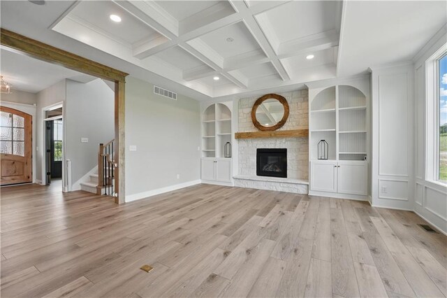 11588 S Houston St, Olathe, KS 66061 - unfurnished living room with light wood-style floors, beam ceiling, baseboards, built in features, and recessed lighting