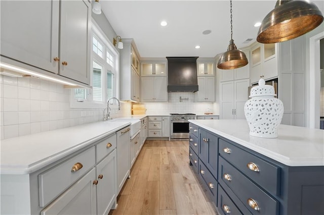 11588 S Houston St, Olathe, KS 66061 - kitchen with custom range hood, a sink, stainless steel range, light wood-type flooring, and light countertops