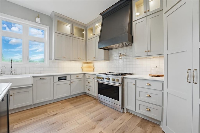 11588 S Houston St, Olathe, KS 66061 - kitchen featuring stainless steel range, wall chimney exhaust hood, a sink, and tasteful backsplash