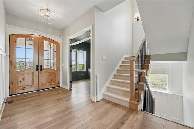 11588 S Houston St, Olathe, KS 66061 - entryway featuring a chandelier, light wood finished floors, stairs, and baseboards