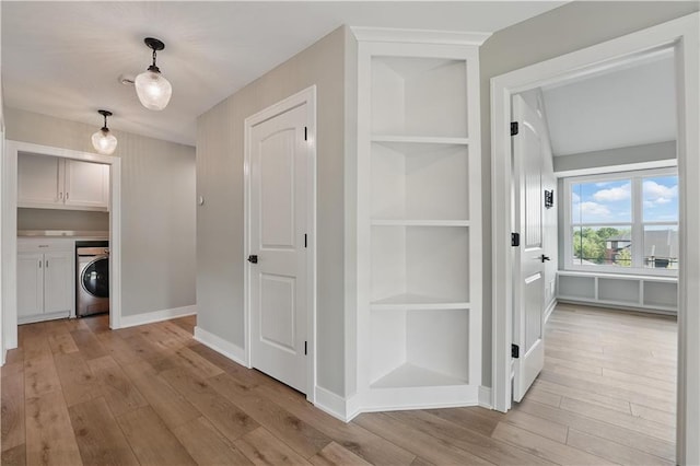 11588 S Houston St, Olathe, KS 66061 - corridor with washer / clothes dryer, built in features, light wood-style flooring, and baseboards