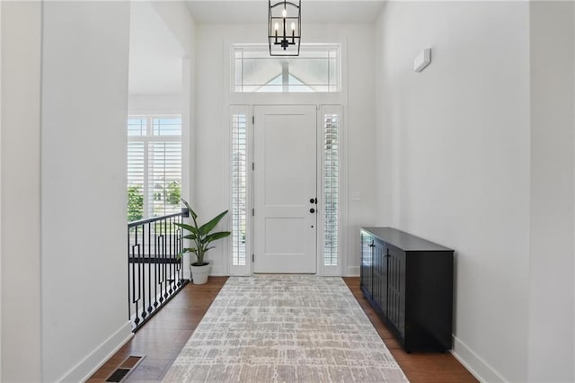 24765 W 89th Ter, Lenexa, KS 66227 - entryway featuring dark wood-type flooring, a chandelier, and baseboards