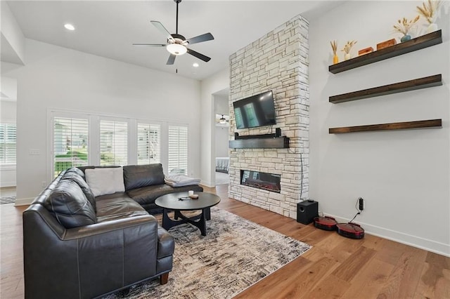 24765 W 89th Ter, Lenexa, KS 66227 - living area with a ceiling fan, a fireplace, baseboards, wood finished floors, and recessed lighting