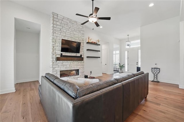 24765 W 89th Ter, Lenexa, KS 66227 - living room with a ceiling fan, baseboards, light wood-style flooring, a fireplace, and recessed lighting