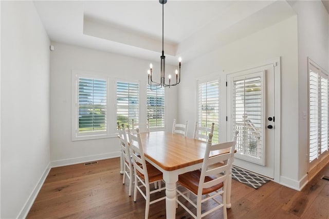 24765 W 89th Ter, Lenexa, KS 66227 - dining space with healthy amount of natural light, hardwood / wood-style flooring, and a chandelier