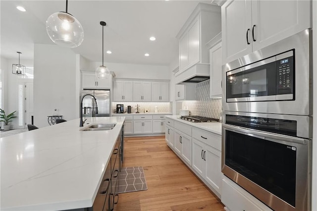 24765 W 89th Ter, Lenexa, KS 66227 - kitchen with stainless steel appliances, a sink, tasteful backsplash, white cabinetry, and recessed lighting