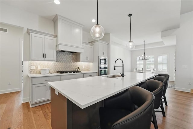 24765 W 89th Ter, Lenexa, KS 66227 - kitchen with a sink, appliances with stainless steel finishes, decorative backsplash, baseboards, and recessed lighting