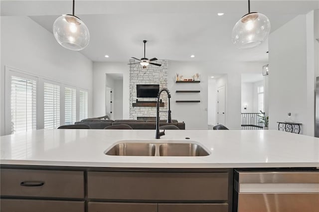 24765 W 89th Ter, Lenexa, KS 66227 - kitchen with open floor plan, stainless steel dishwasher, a sink, ceiling fan, and a stone fireplace