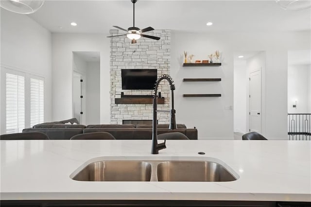 24765 W 89th Ter, Lenexa, KS 66227 - kitchen featuring a fireplace, open floor plan, ceiling fan, a sink, and recessed lighting