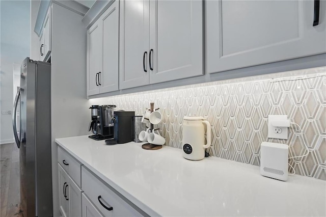 24765 W 89th Ter, Lenexa, KS 66227 - kitchen featuring freestanding refrigerator, light countertops, and decorative backsplash