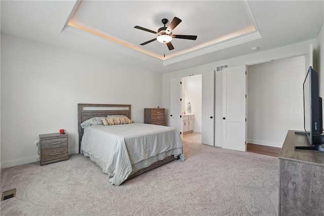 24765 W 89th Ter, Lenexa, KS 66227 - bedroom with a tray ceiling, carpet flooring, baseboards, a ceiling fan, and ensuite bath