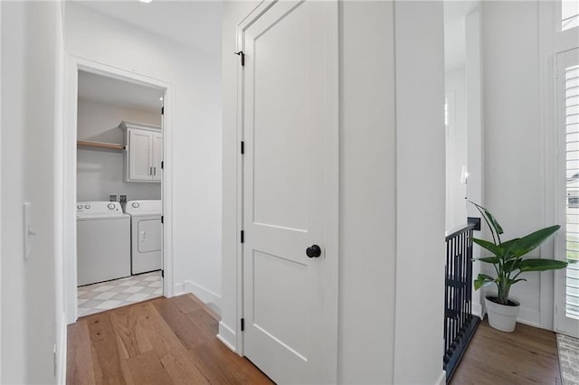 24765 W 89th Ter, Lenexa, KS 66227 - corridor featuring separate washer and dryer, light wood-style floors, and baseboards
