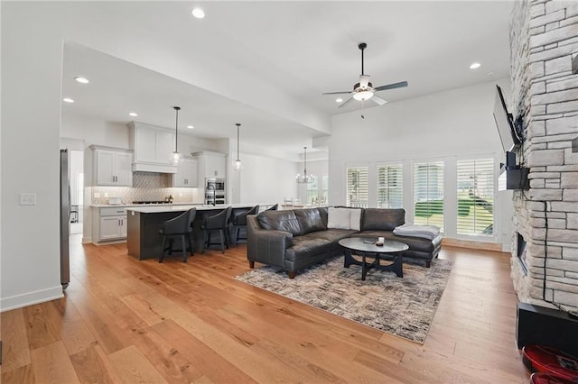 24765 W 89th Ter, Lenexa, KS 66227 - living room with a ceiling fan, light wood finished floors, recessed lighting, a chandelier, and a fireplace