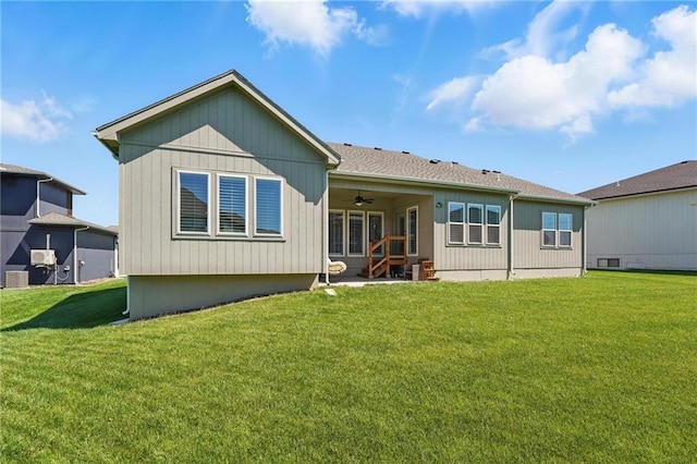 24765 W 89th Ter, Lenexa, KS 66227 - rear view of property with ceiling fan and a yard