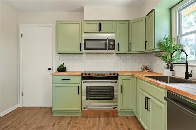 11524 Sunnyslope Dr, Kansas City, MO 64134 - kitchen with green cabinetry and stainless steel appliances