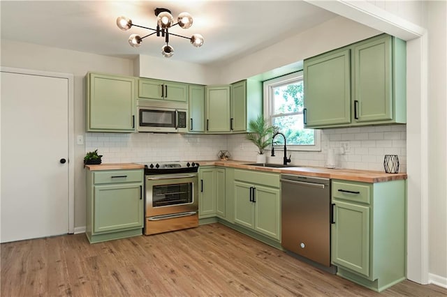 11524 Sunnyslope Dr, Kansas City, MO 64134 - kitchen featuring green cabinets, butcher block counters, appliances with stainless steel finishes, and a sink