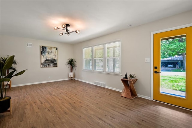 11524 Sunnyslope Dr, Kansas City, MO 64134 - entryway with wood finished floors, a chandelier, and baseboards