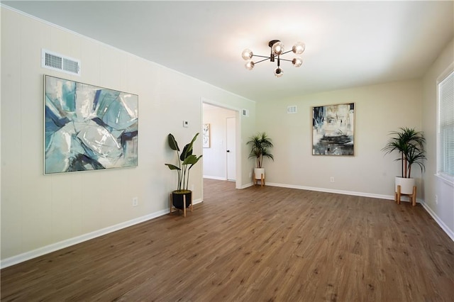 11524 Sunnyslope Dr, Kansas City, MO 64134 - unfurnished room with a chandelier, wood finished floors, and baseboards