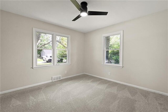 11524 Sunnyslope Dr, Kansas City, MO 64134 - unfurnished room with healthy amount of natural light, carpet floors, a ceiling fan, and baseboards