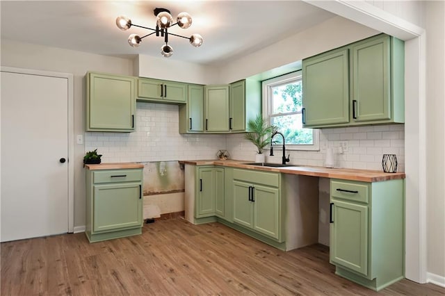11524 Sunnyslope Dr, Kansas City, MO 64134 - kitchen featuring green cabinetry, a sink, wood counters, and light wood finished floors