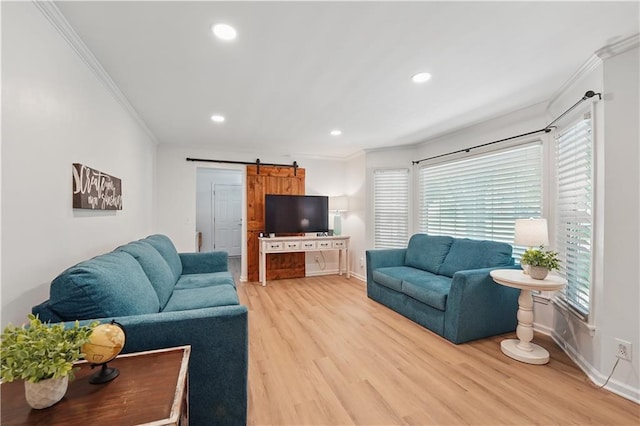 9849 Riggs St, Overland Park, KS 66212 - living room with a barn door, crown molding, light wood-style floors, recessed lighting, and baseboards