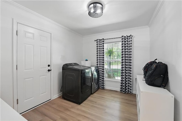 9849 Riggs St, Overland Park, KS 66212 - laundry room featuring washer and clothes dryer, crown molding, light wood-type flooring, and baseboards