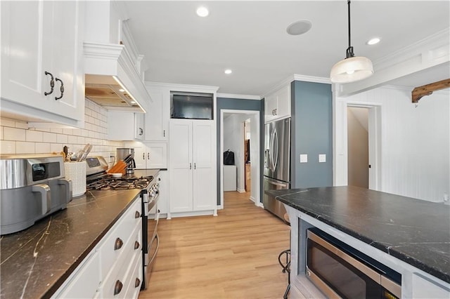 9849 Riggs St, Overland Park, KS 66212 - kitchen with appliances with stainless steel finishes, ornamental molding, backsplash, white cabinets, and light wood finished floors