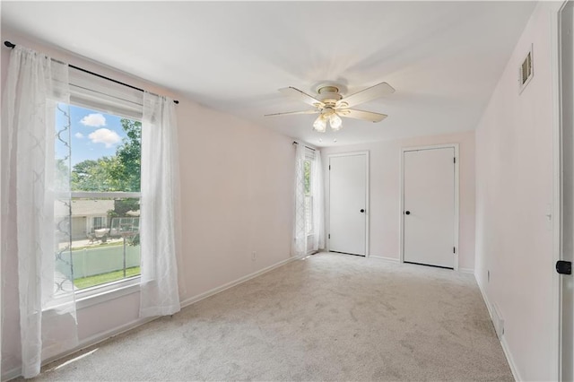 9849 Riggs St, Overland Park, KS 66212 - unfurnished bedroom featuring carpet flooring, two closets, baseboards, and a ceiling fan