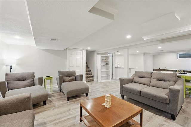 9849 Riggs St, Overland Park, KS 66212 - living area featuring light wood finished floors, ornamental molding, baseboards, stairs, and recessed lighting